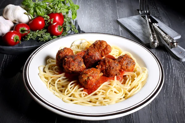 Italian pasta with meatball gray background