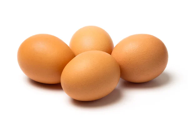 Quatre œufs isolés sur fond blanc — Photo