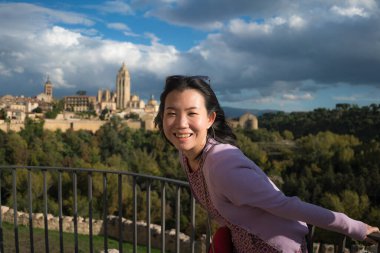 Genç Asyalı kadın açık hava yaşam tarzı portresi - mutlu ve güzel Japon kız Avrupa 'da tatil gezileri sırasında neşeli gülümseyerek eski kasaba manzarasından keyif alıyor