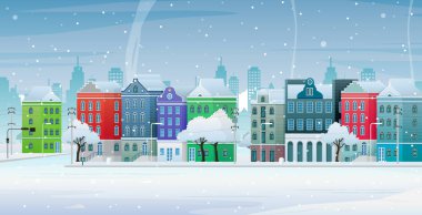 Karlı bir caddenin kenarındaki eski binalar..