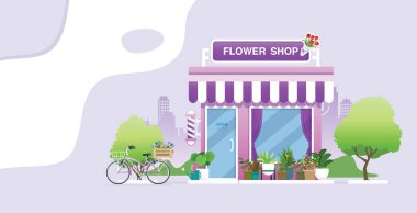 Süslü bitkileri olan bir çiçekçi ve şehir içinde bisiklet dükkânı..