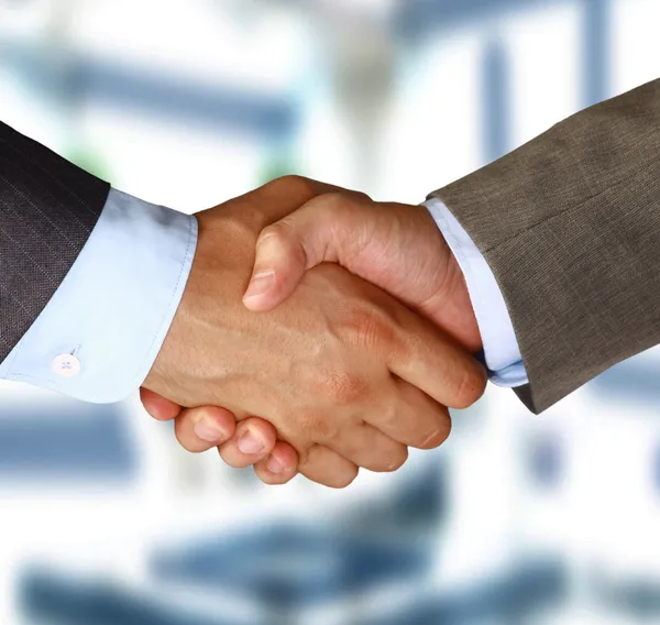 Closeup of a business hand shake between two colleagues Royalty Free Stock Photos