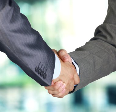 Closeup of a business hand shake between two colleagues clipart