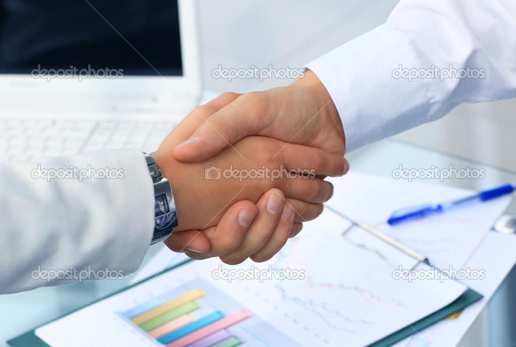 Closeup of a business hand shake between two colleagues