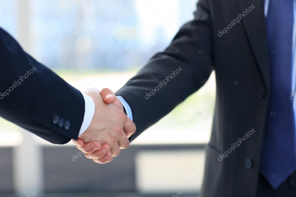 Closeup of a business hand shake between two colleagues