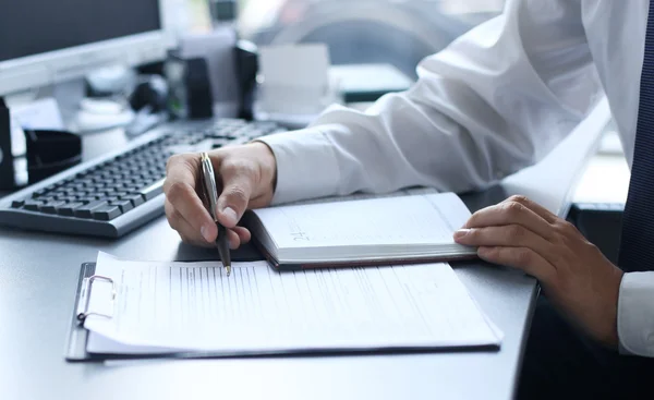 Close-up of male hands pointing at business document — Stock Photo, Image