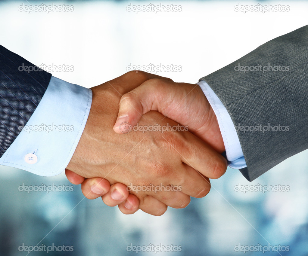 Closeup of a business hand shake between two colleagues