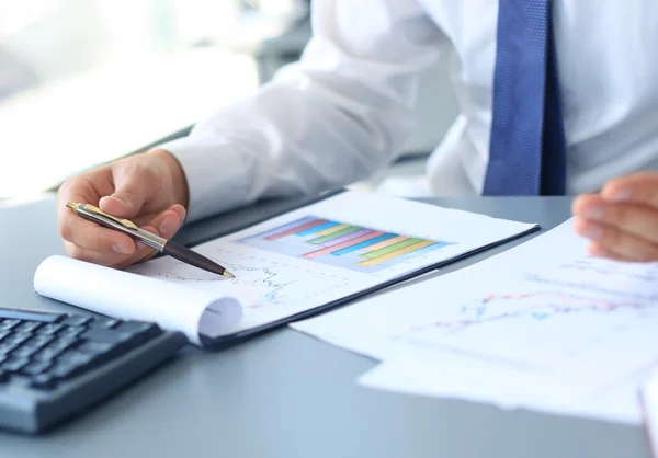 Close-up of graphs and charts analyzed by businessman — Stock Photo, Image