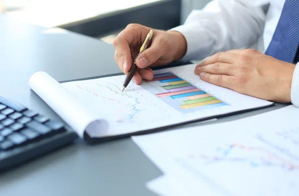 Close-up of graphs and charts analyzed by businessman — Stock Photo, Image