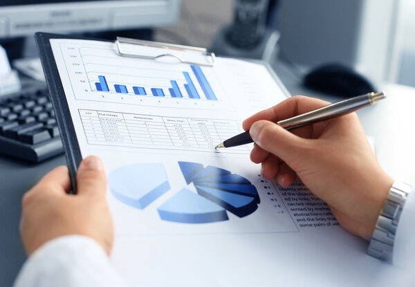 Image of human hand pointing at touchscreen in working environment at meeting