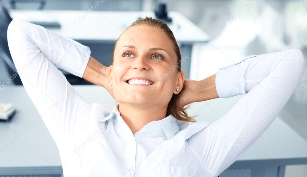 Portrait of smiling woman sitting and resting inside the office