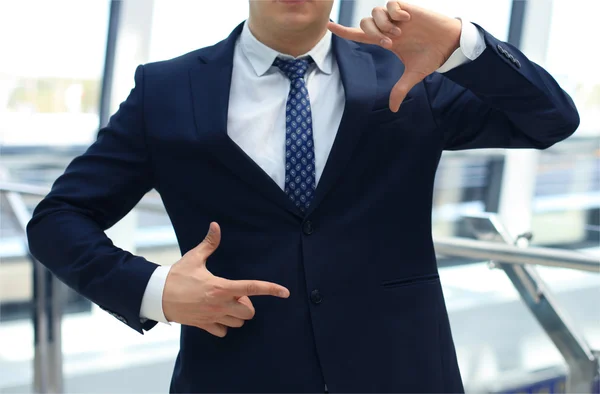 Businessman showing hand square — Stock Photo, Image