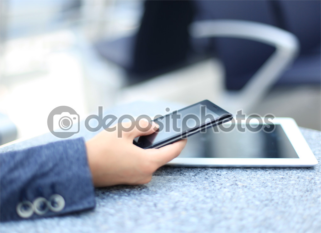 Close up of a business woman using mobile smart phone