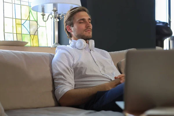 Tired Young Male Sitting Closed Eyes Sofa Laptop Standing Him — Stock Photo, Image