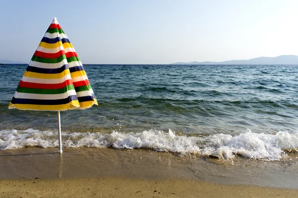 Colorful umbrella on the seashore — Stock Photo, Image