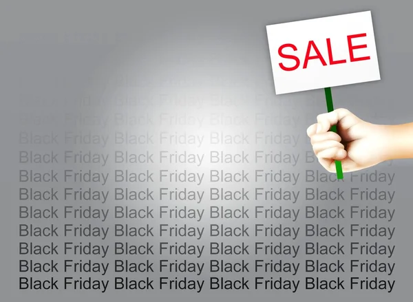 Hand met een plakkaat van tekst verkoop op zwarte vrijdag achtergrond — Stockfoto