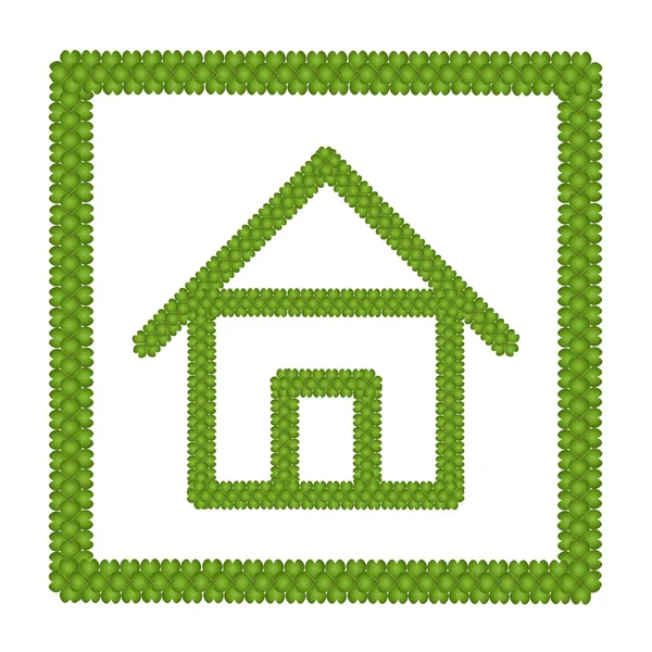 Trevo verde de quatro folhas de ícone de casa em um quadro — Fotografia de Stock