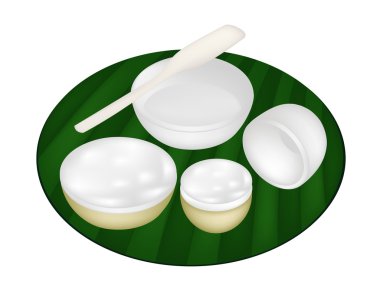 Hindistan cevizi custard yeşil muz yaprağı üzerinde Tay tatlı