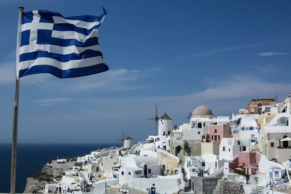Bandera griega en la costa de Santorini Fotos de stock