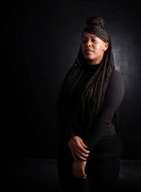 studio portrait of a confident young black woman conveying the strength and personality of the afro race. High quality photo