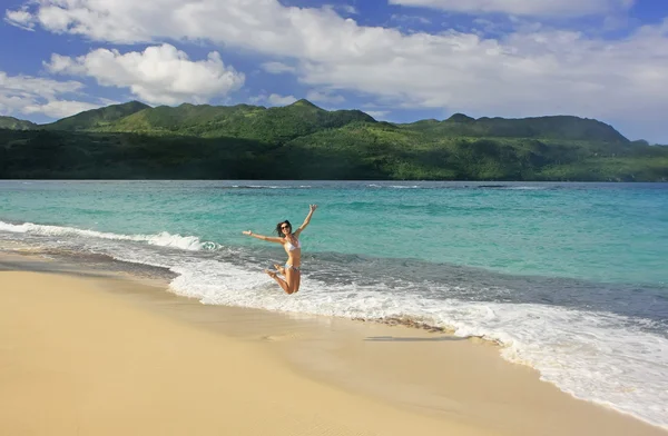 Young woman in bikini jumping at Rincon beach, Samana peninsula — Stock Photo, Image