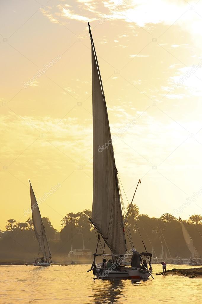 Felucca boats sailing on the Nile river at sunset, Luxor