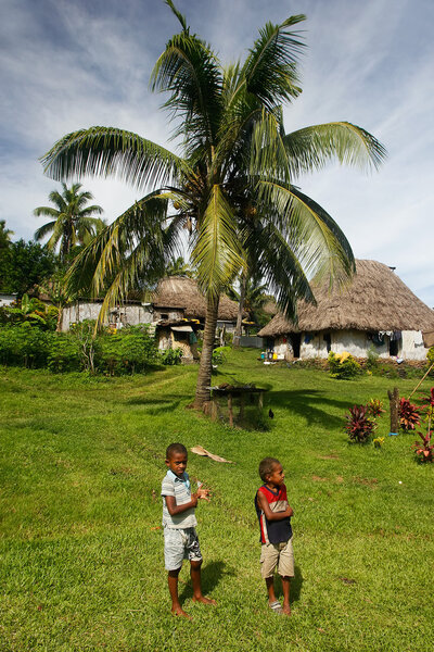 Young boys walking around Navala village, Viti Levu, Fiji