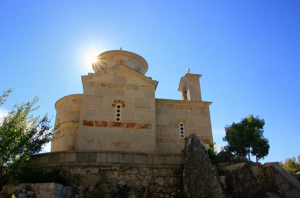 Lower Church of Ostrog Monastery with sunburst, Montenegro — Stock Photo, Image