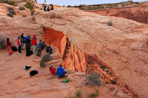 Photographers and tourists watching sunrise at  Mesa Arch, Canyo — Stock Photo, Image