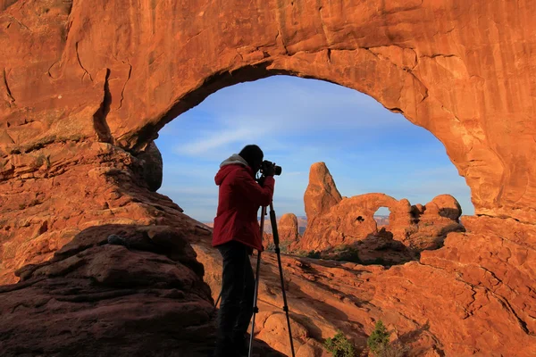 Silhouetted person photographing North Window and Turret Arch, A — Stock Photo, Image