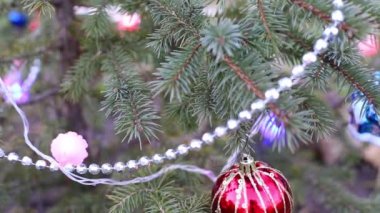 Noel ağacı oyuncaklarla ve açık havada parlayan çelenklerle. Yeni Yıl Arifesi