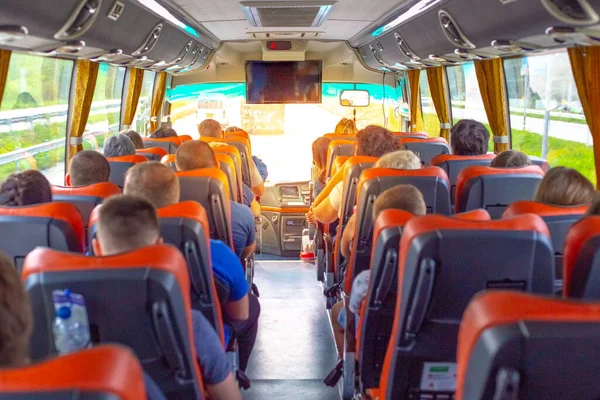 Tourists ride a bus on an excursion to see the sights of the city