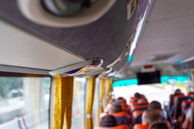 Turistlerle dolu otobüs arka planda bulanık bir geziye çıkıyor.