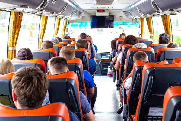 Tourists ride a bus on an excursion to see the sights of the city