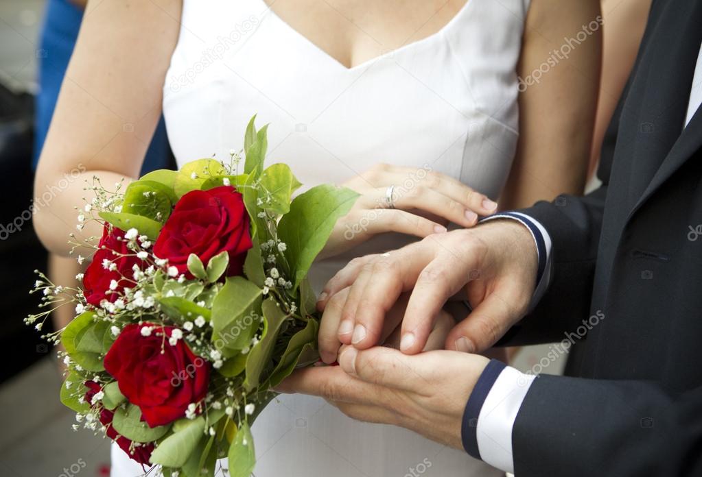 Hands on wedding bouquet
