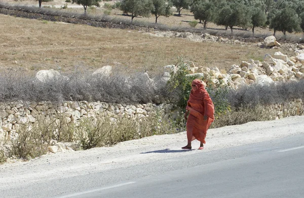 Арабская женщина идет по дороге — стоковое фото