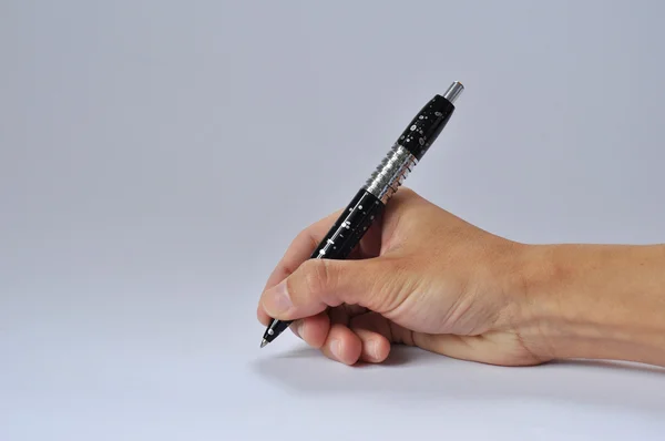 Pen in de hand schrijven op een homogene lichte achtergrond — Stockfoto