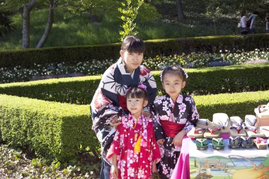 Asian family at Cherry Blossom Festival clipart