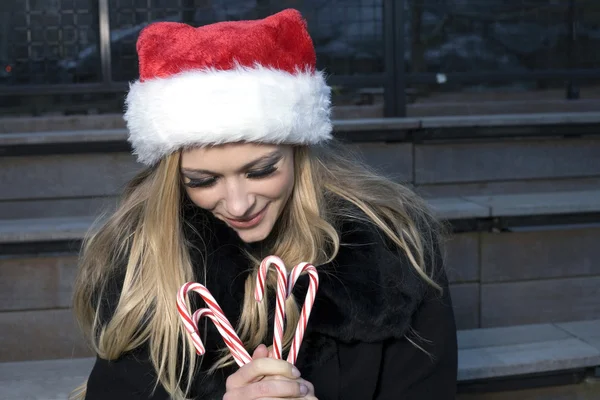 Girl with candy canes — Stock Photo, Image