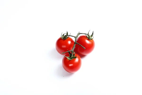 Three small tomatoes on white — Stock Photo, Image