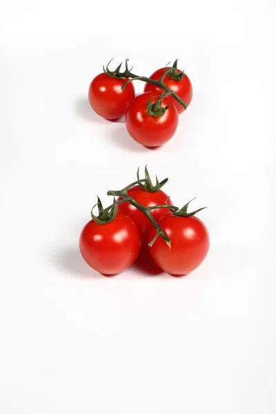 Six cherry tomatoes on white — Stock Photo, Image