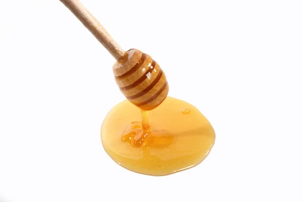 Tablespoon honey on white — Stock Photo, Image