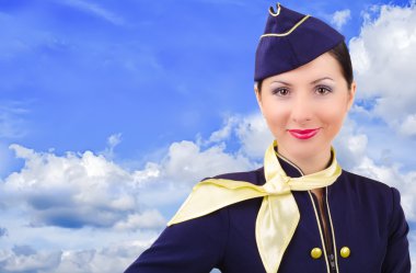 arka plan gökyüzü üzerinde güzel genç gülümseyen hostes