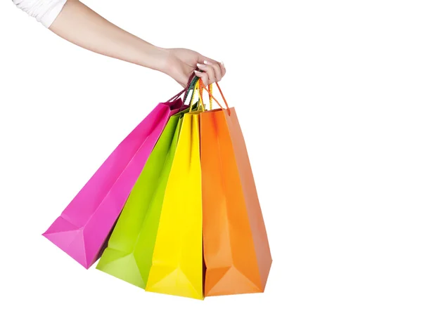 Mano femenina sosteniendo bolsas de compras coloridas —  Fotos de Stock