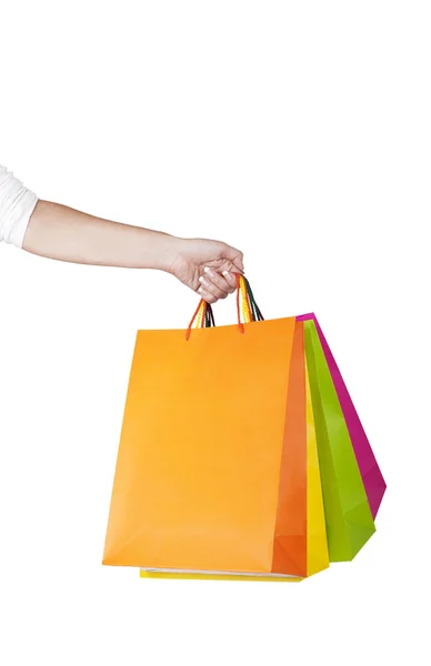 Mano femenina sosteniendo bolsas de compras coloridas — Foto de Stock