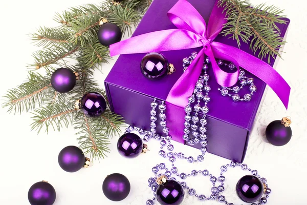 Purple gift box with christmas balls — Stock Photo, Image