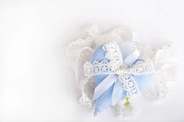 Blue textile heart with a bow from lace — Stock Photo, Image