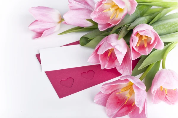 A bunch of pink tulips with a blank card for greetings — Stock Photo, Image