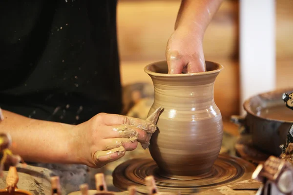 Close-up of hands making pottery on a wheel Stock Image