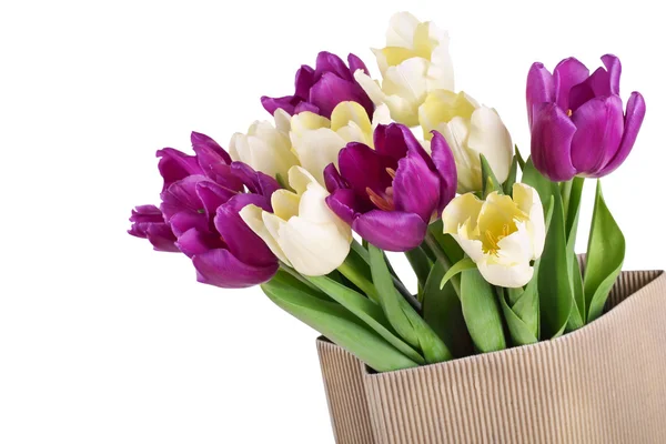 Bouquet from yellow and purple tulips in a paper package — Stock Photo, Image